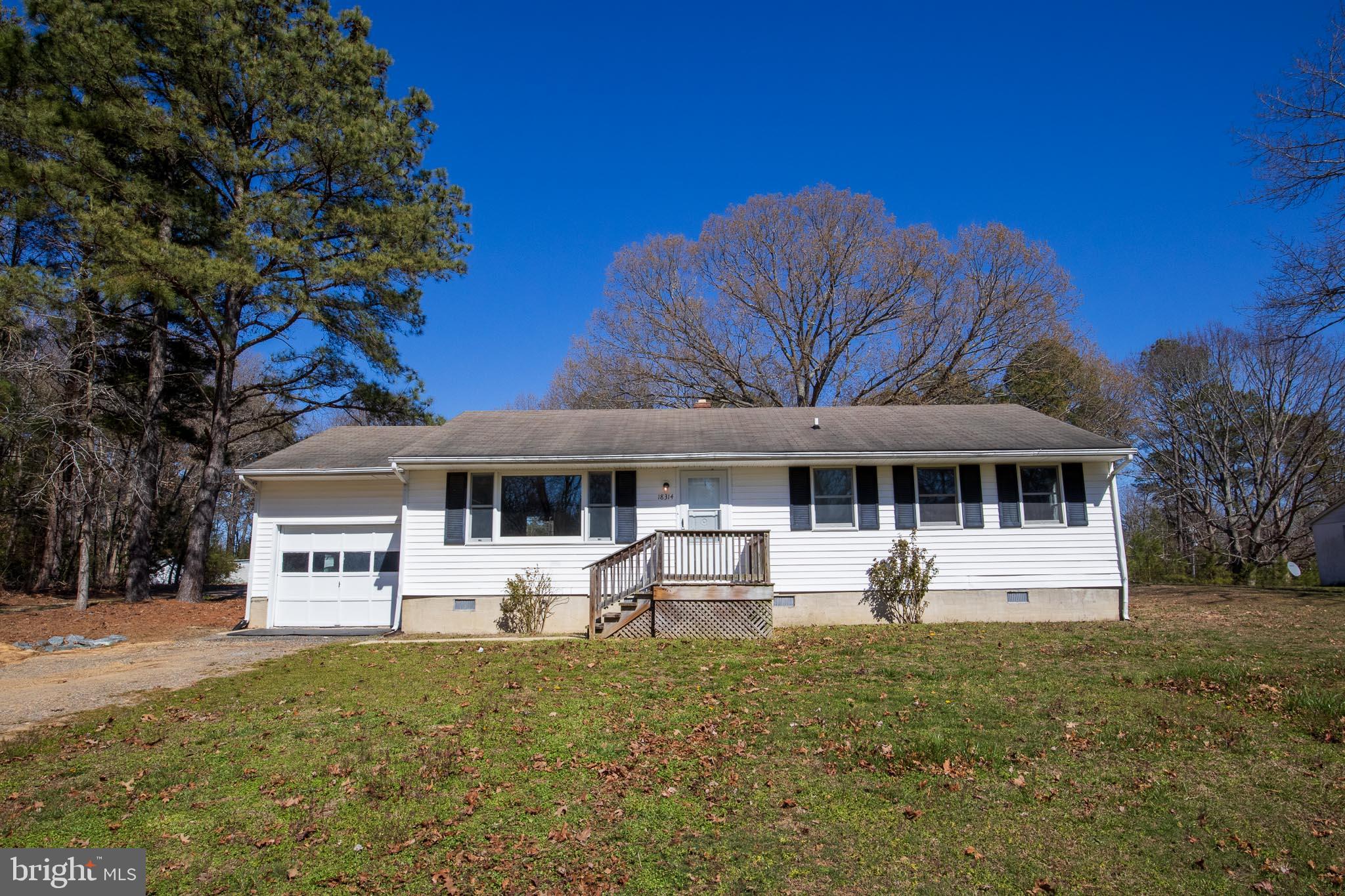 a view of a house with backyard sitting area and garden