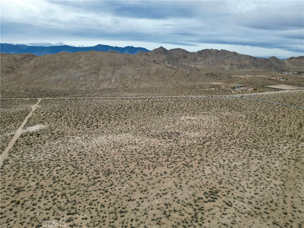 a view of a yard with mountains in the background