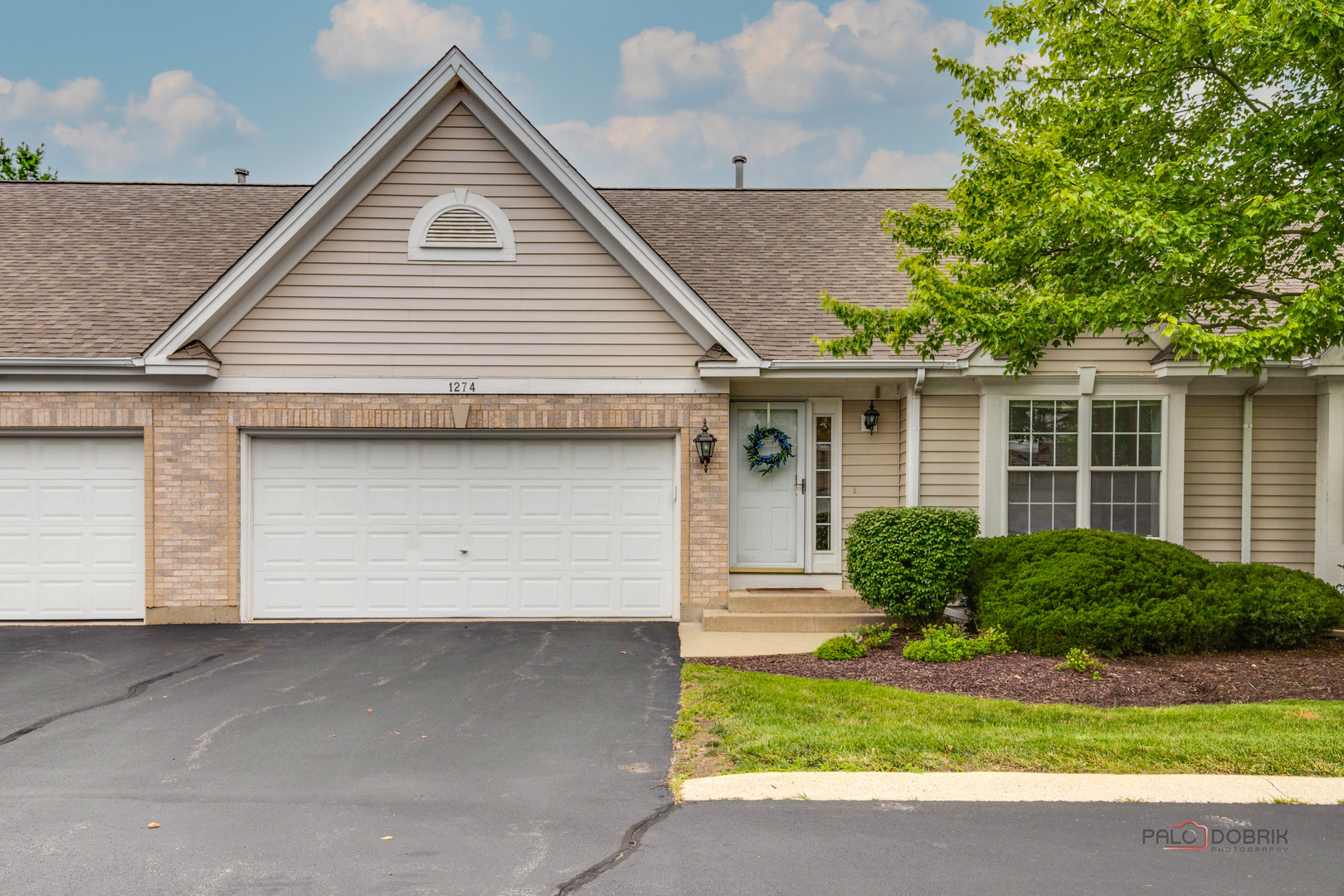 a front view of a house with a yard and garage