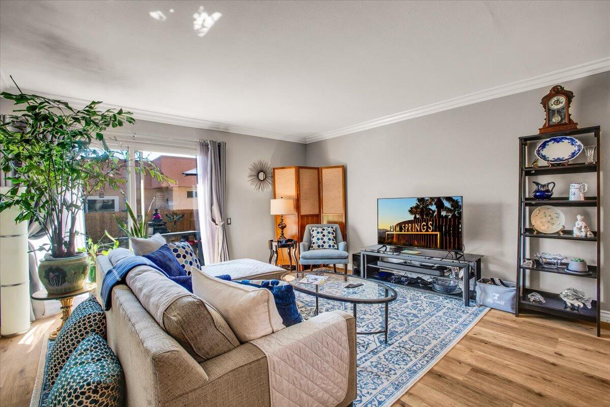 a living room with furniture a flat screen tv and a bookshelf