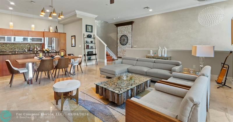 a living room with furniture a rug and a chandelier