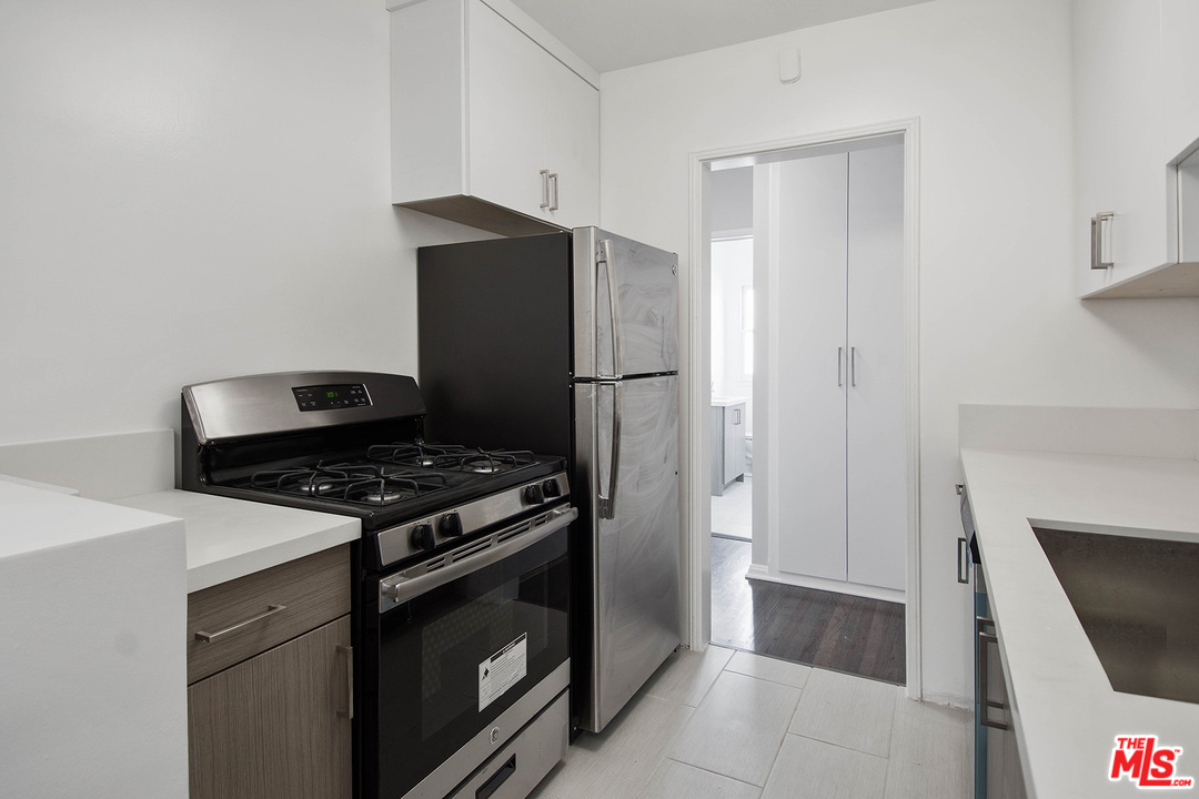 a kitchen with a stove and a refrigerator