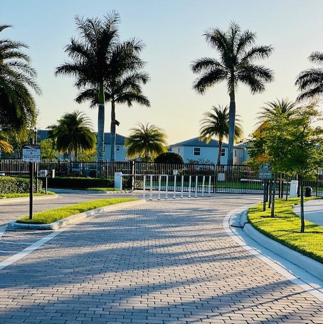 a view of swimming pool with palm trees