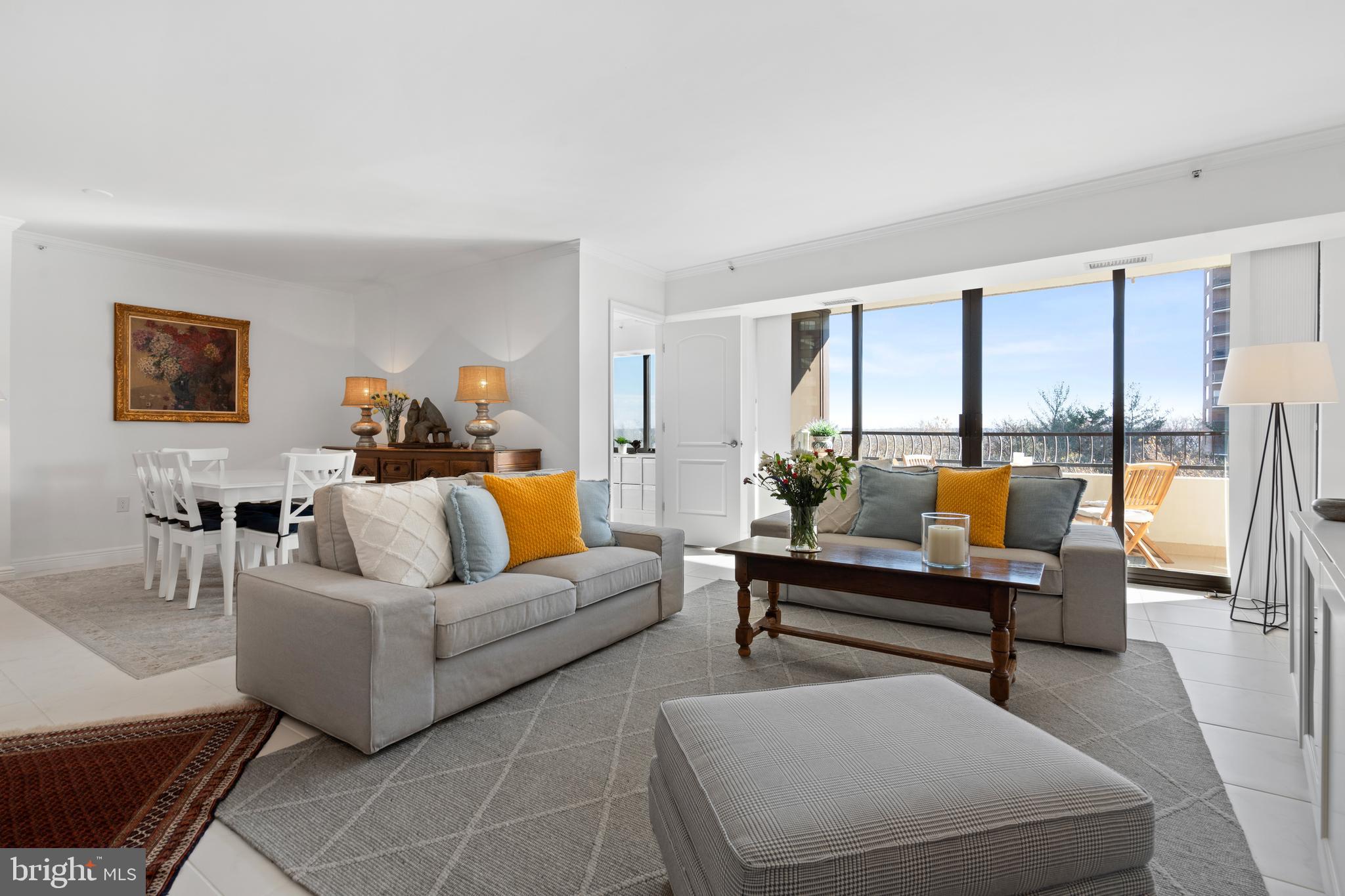 a living room with furniture and a floor to ceiling window