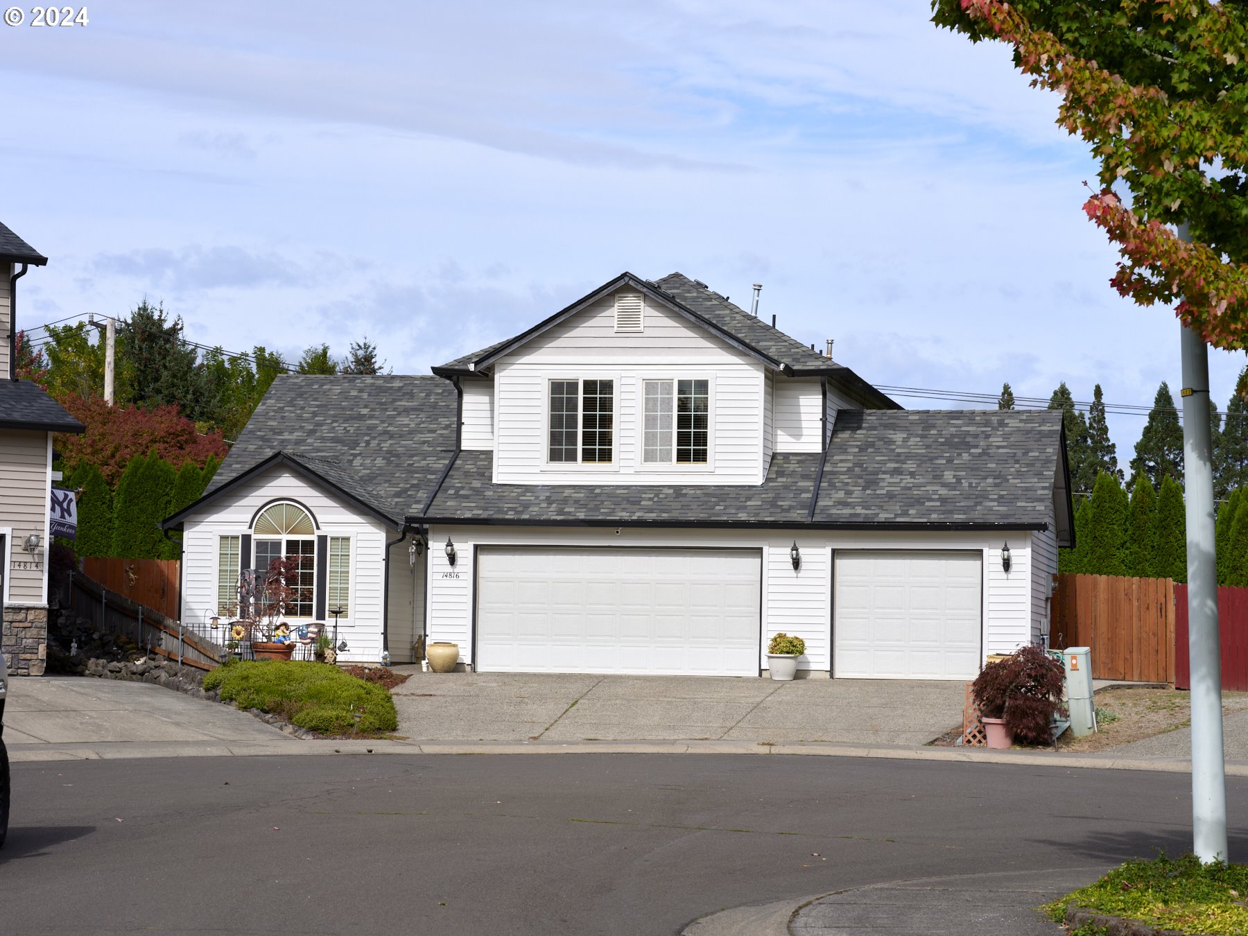 a front view of a house with a garden and garage