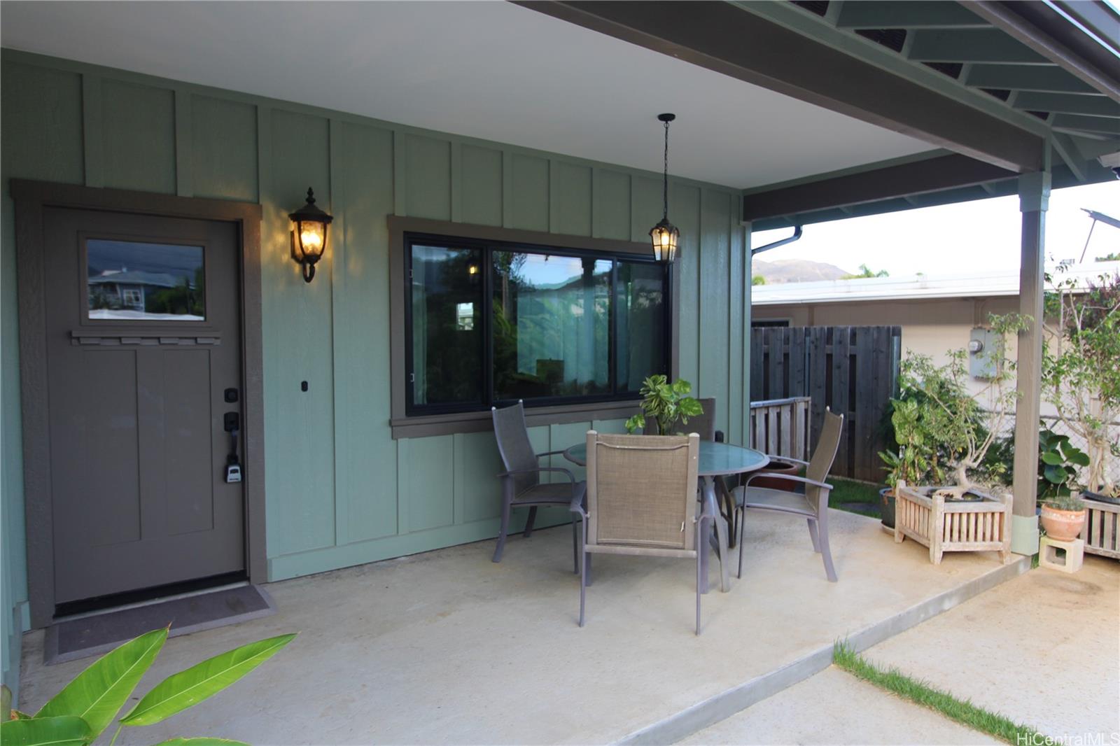 a view of a patio with a table and chairs