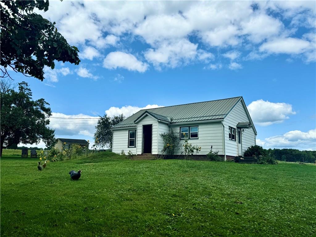 a front view of house with yard and green space