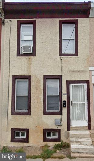 a couple of potted plants in front of a house