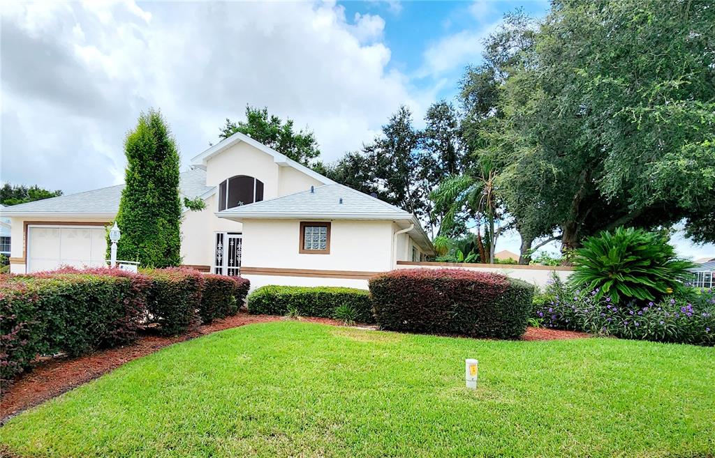 a front view of house with yard and green space