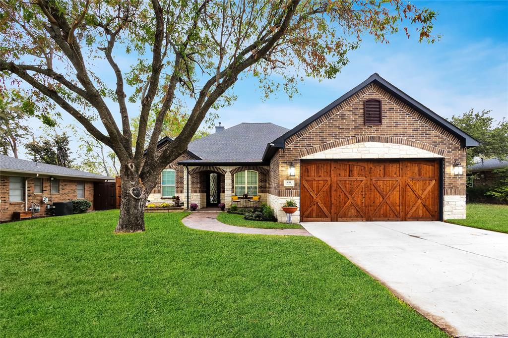 a view of a house with a yard and tree