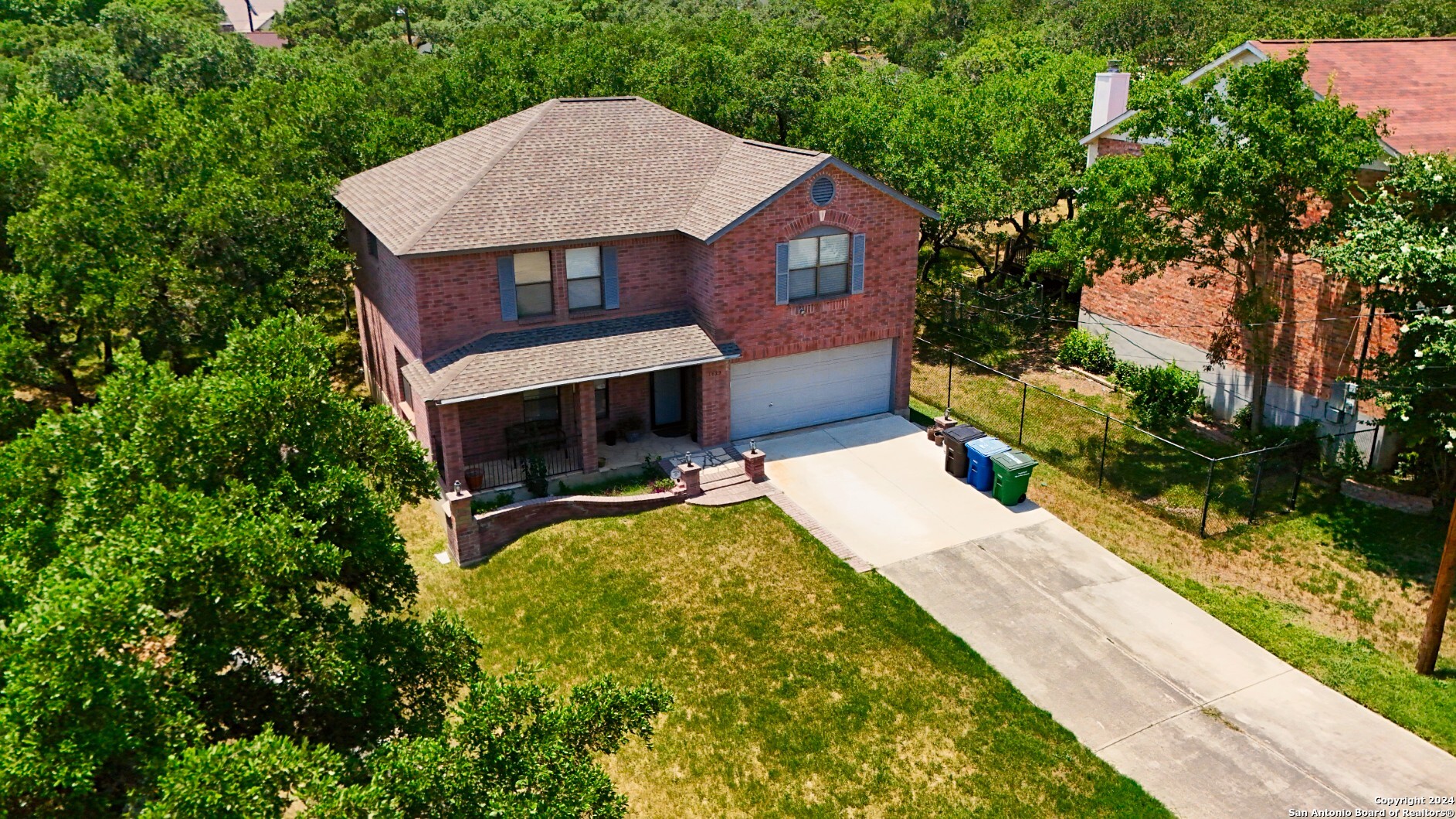 a aerial view of a house with swimming pool next to a big yard