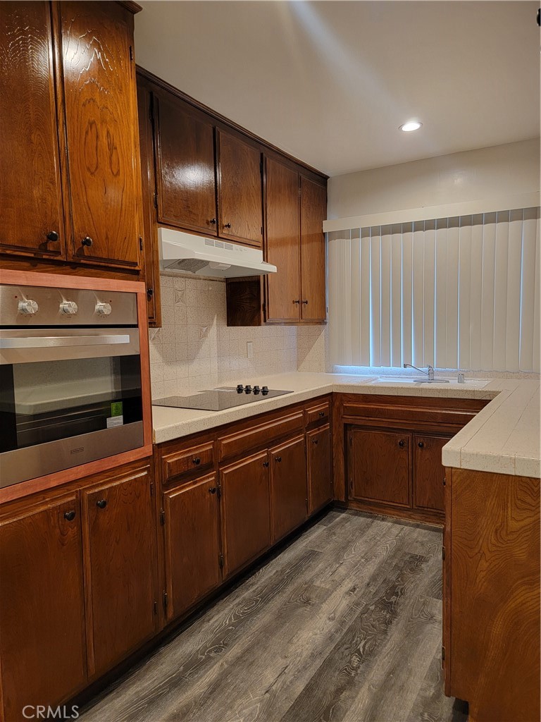 a kitchen with granite countertop a sink and cabinets