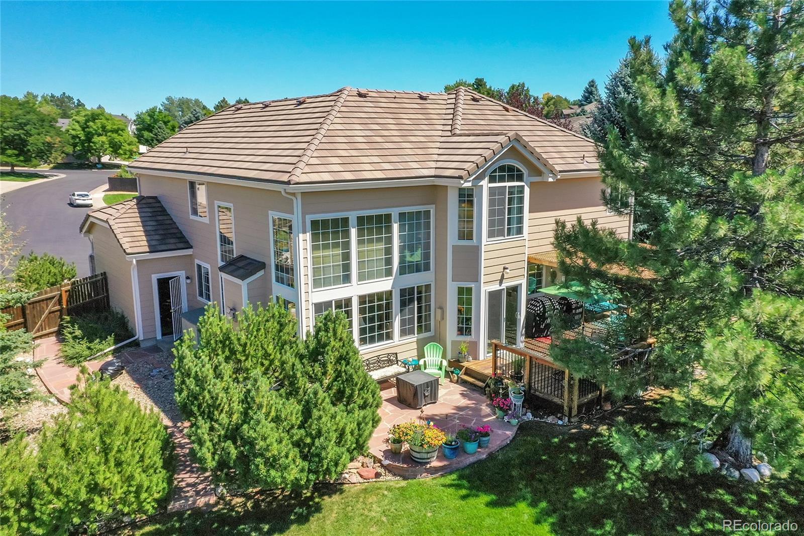 a view of a house with backyard sitting area and garden