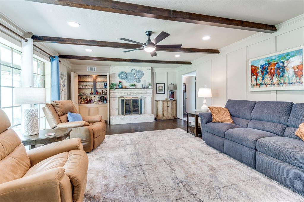 a living room with furniture ceiling fan and a fireplace