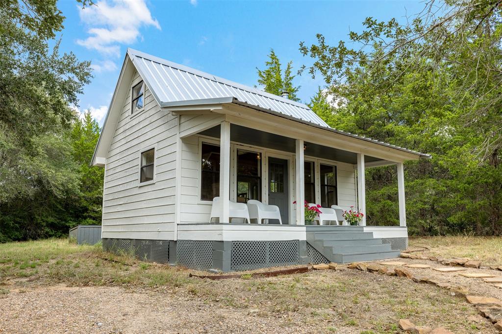 a front view of a house with a yard and porch