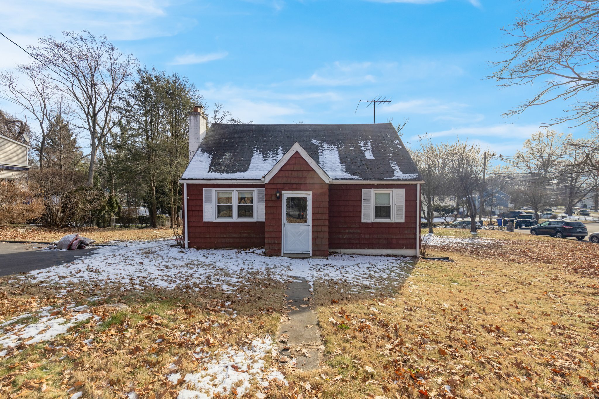 a view of a house with a yard covered in snow