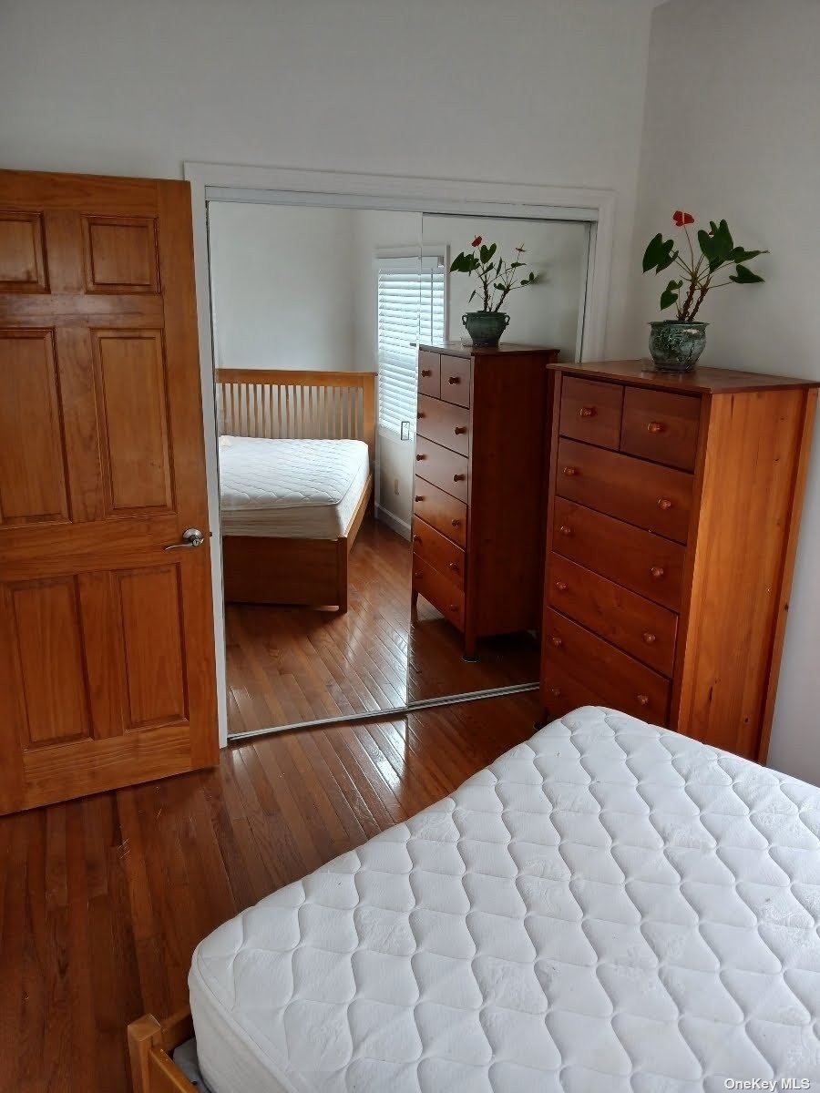 a bedroom with a bed and a potted plant