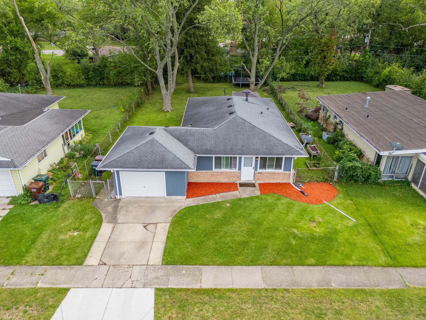 a aerial view of a house with swimming pool and a yard