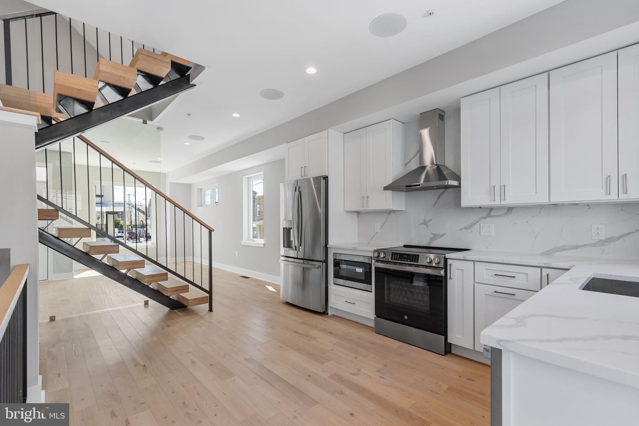 a kitchen with stainless steel appliances granite countertop a stove and a refrigerator