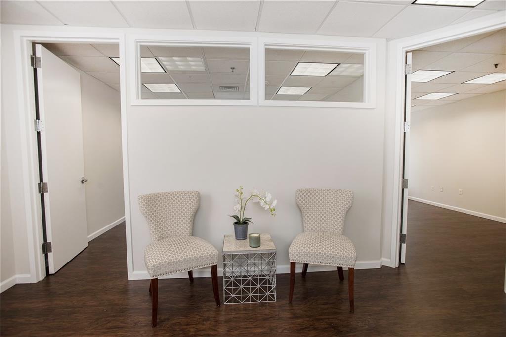 a view of a room with furniture and wooden floor