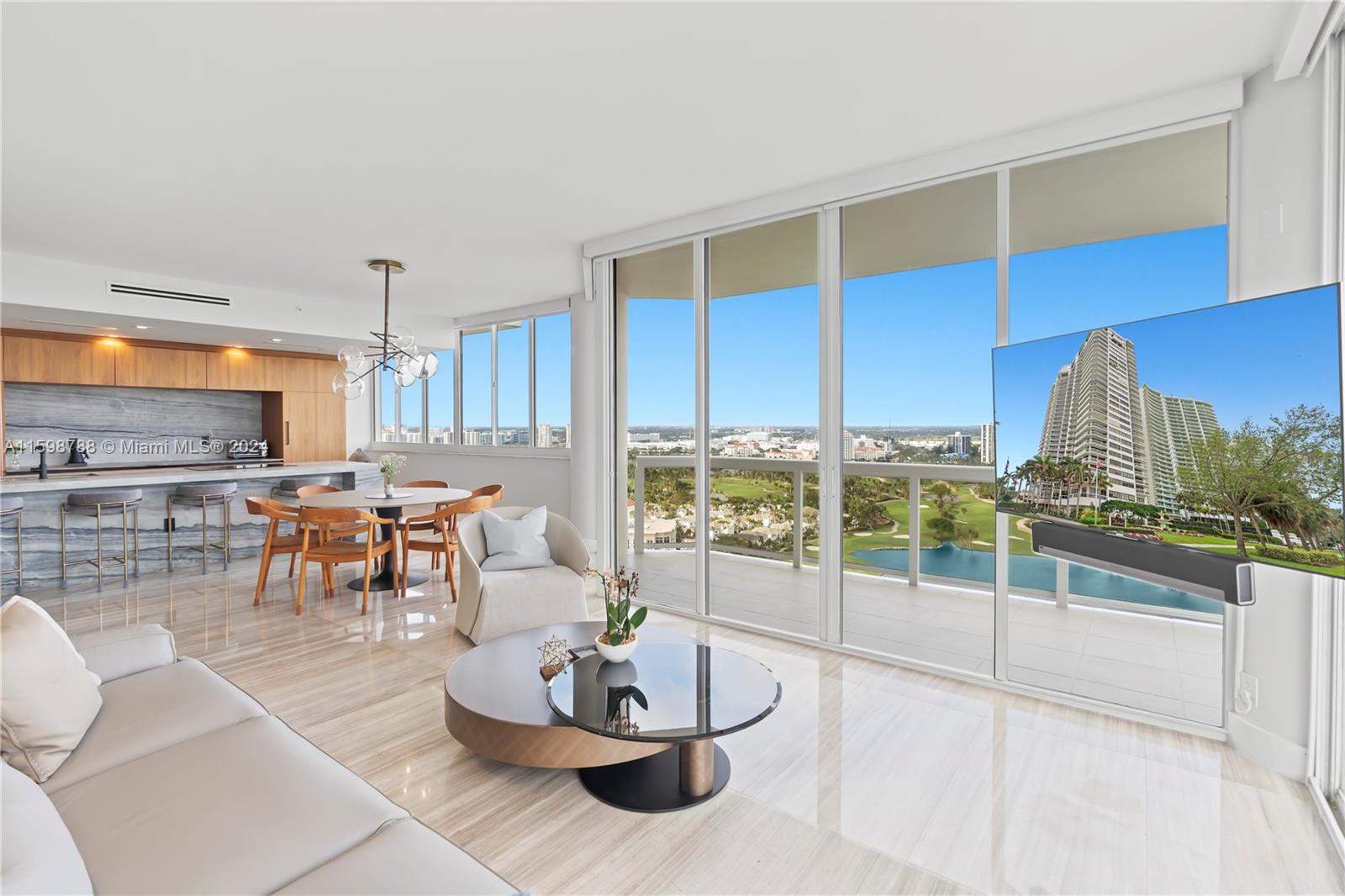 a living room with furniture and a floor to ceiling window