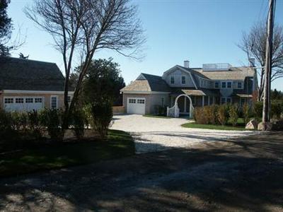 a view of a house next to a yard