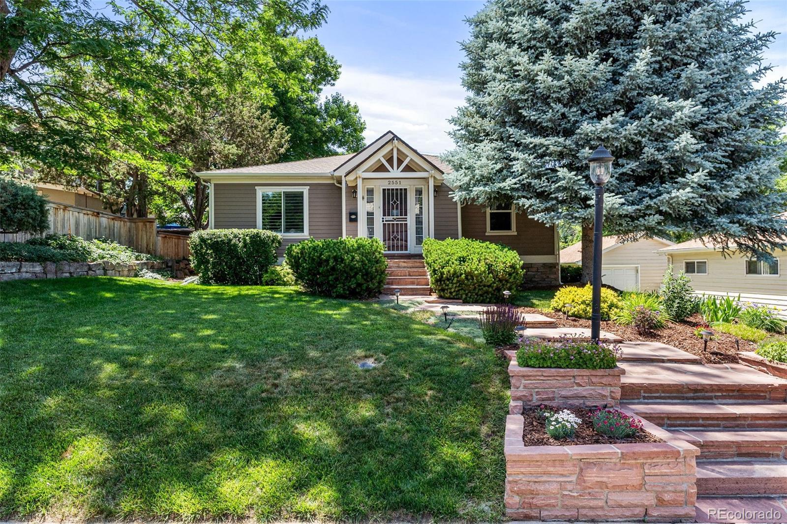 a front view of a house with garden