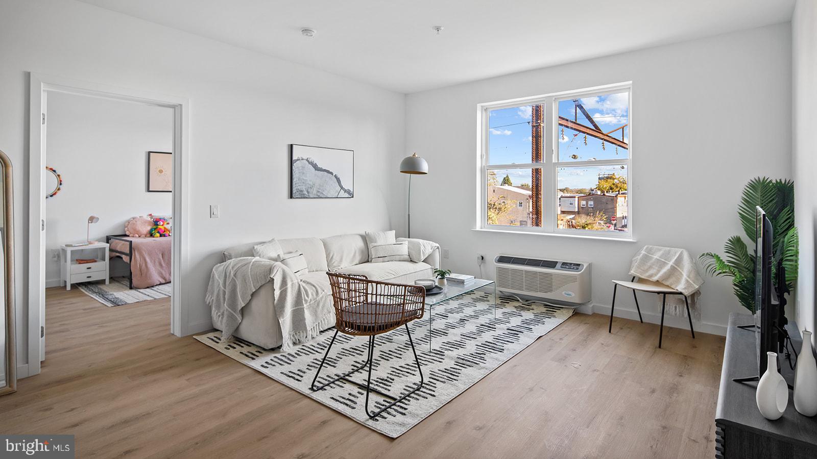 a living room with furniture a rug and a window