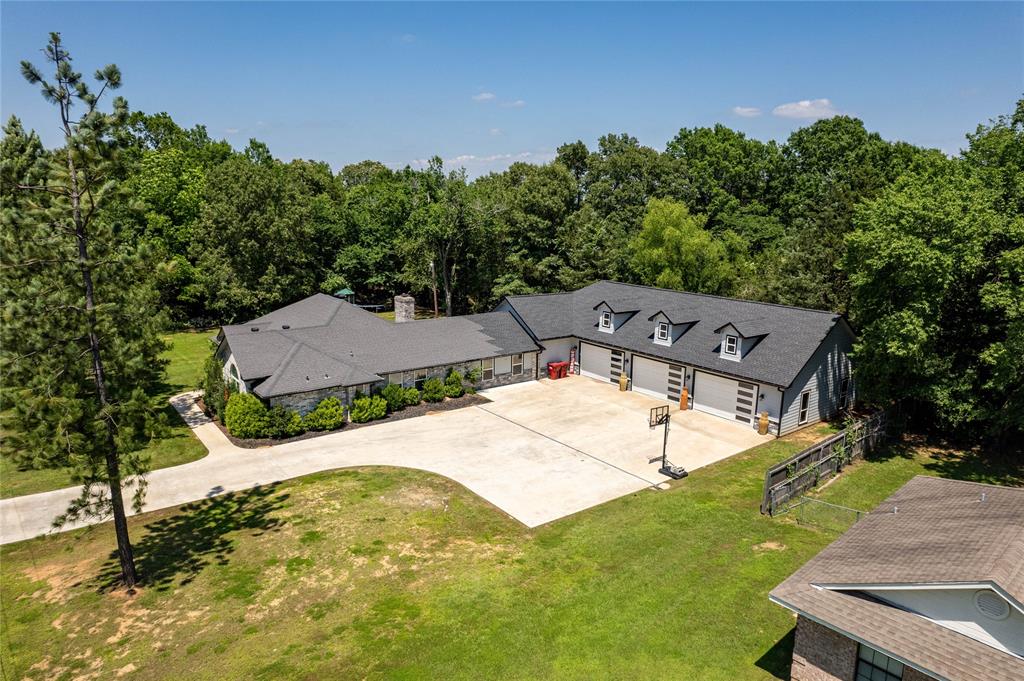 an aerial view of a house with garden space and street view