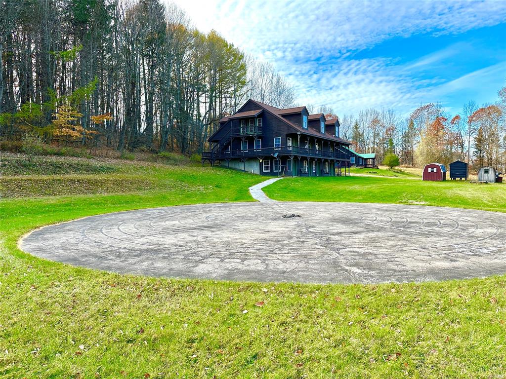 a view of a house with a yard and a fountain