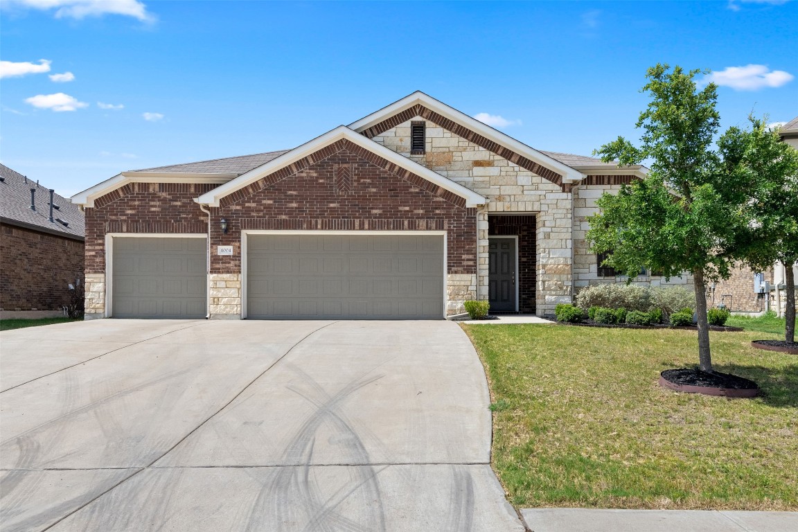 a front view of a house with a yard and garage