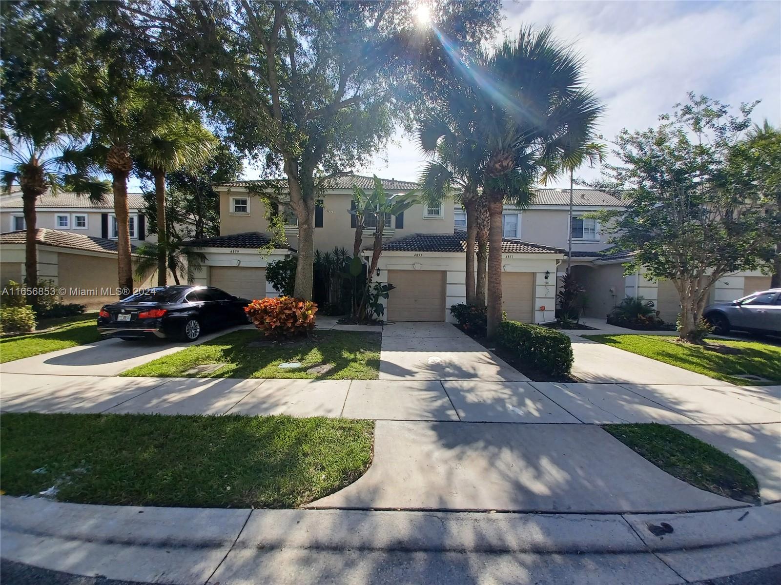 a view of a house with yard and sitting area