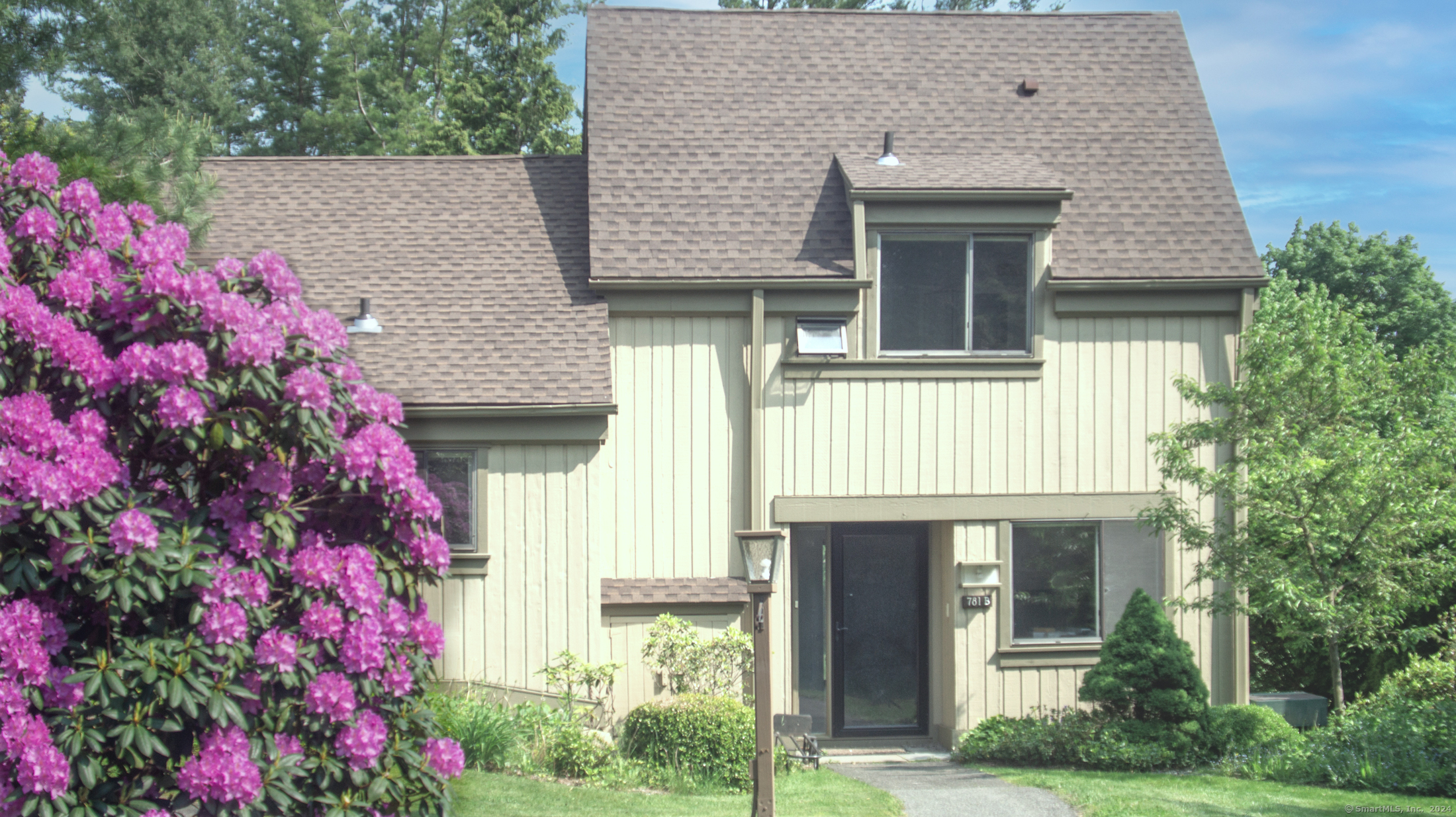 a front view of a house with a garden