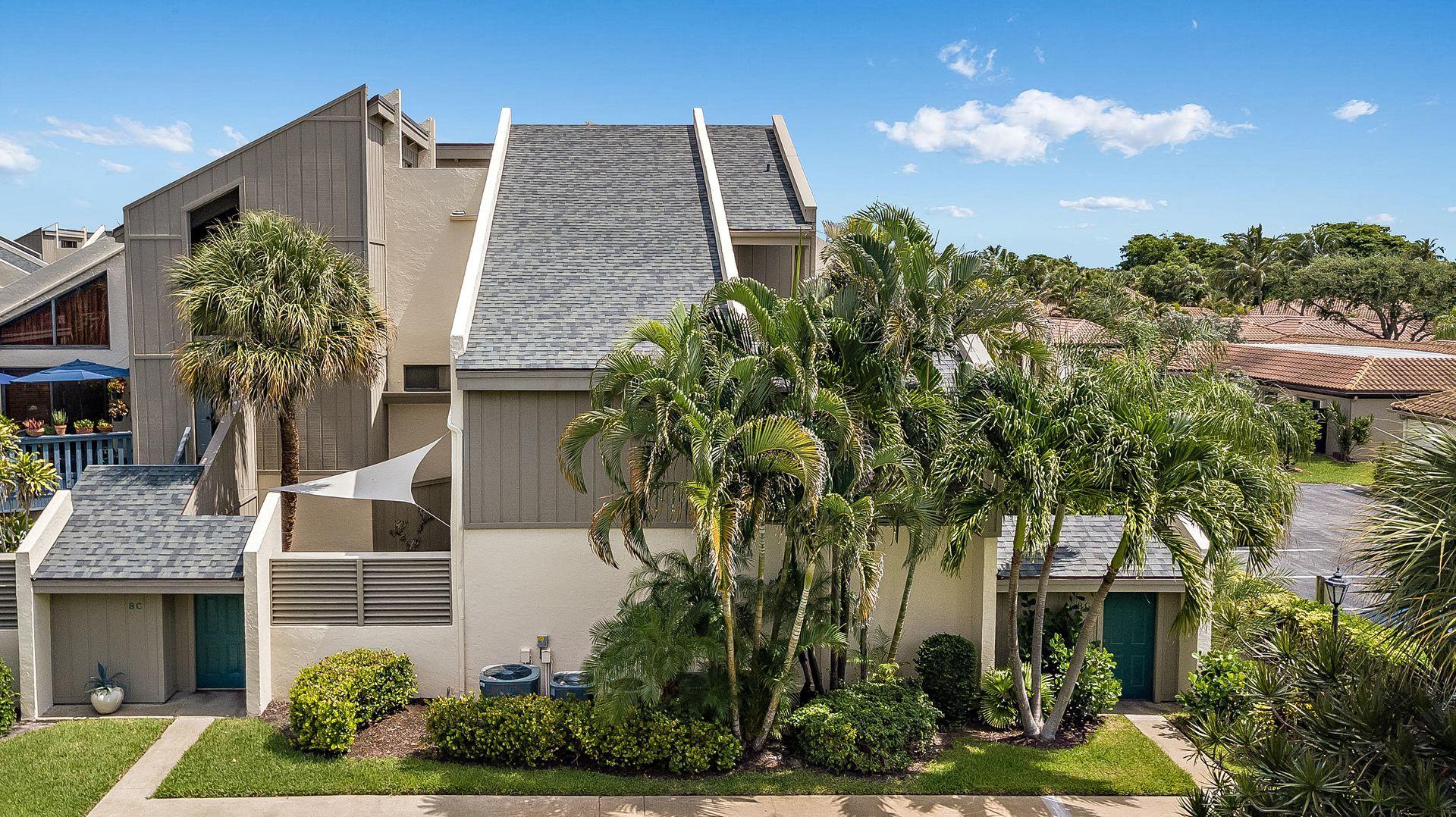 a aerial view of a house with a yard and potted plants