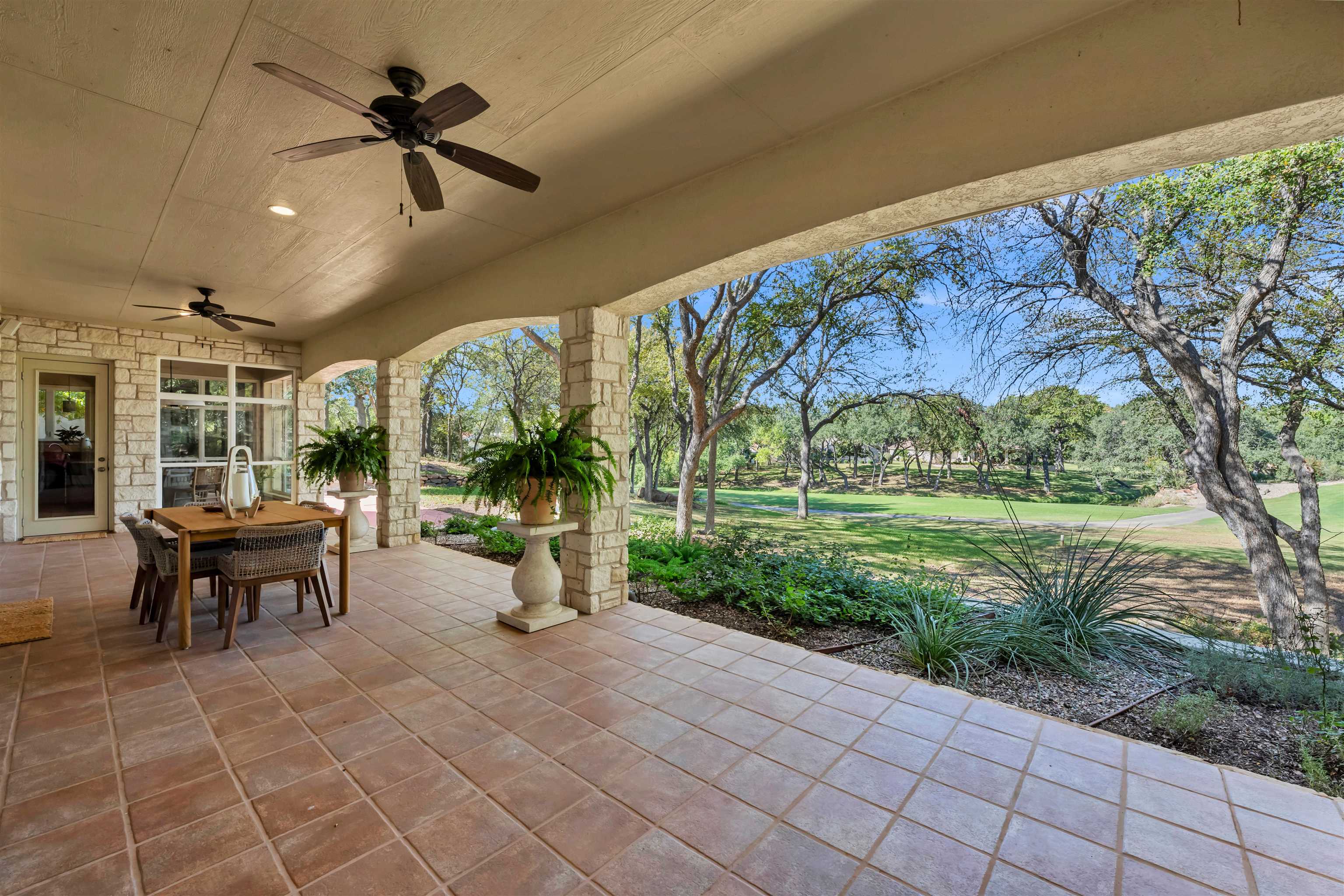 a view of a porch with furniture and a yard