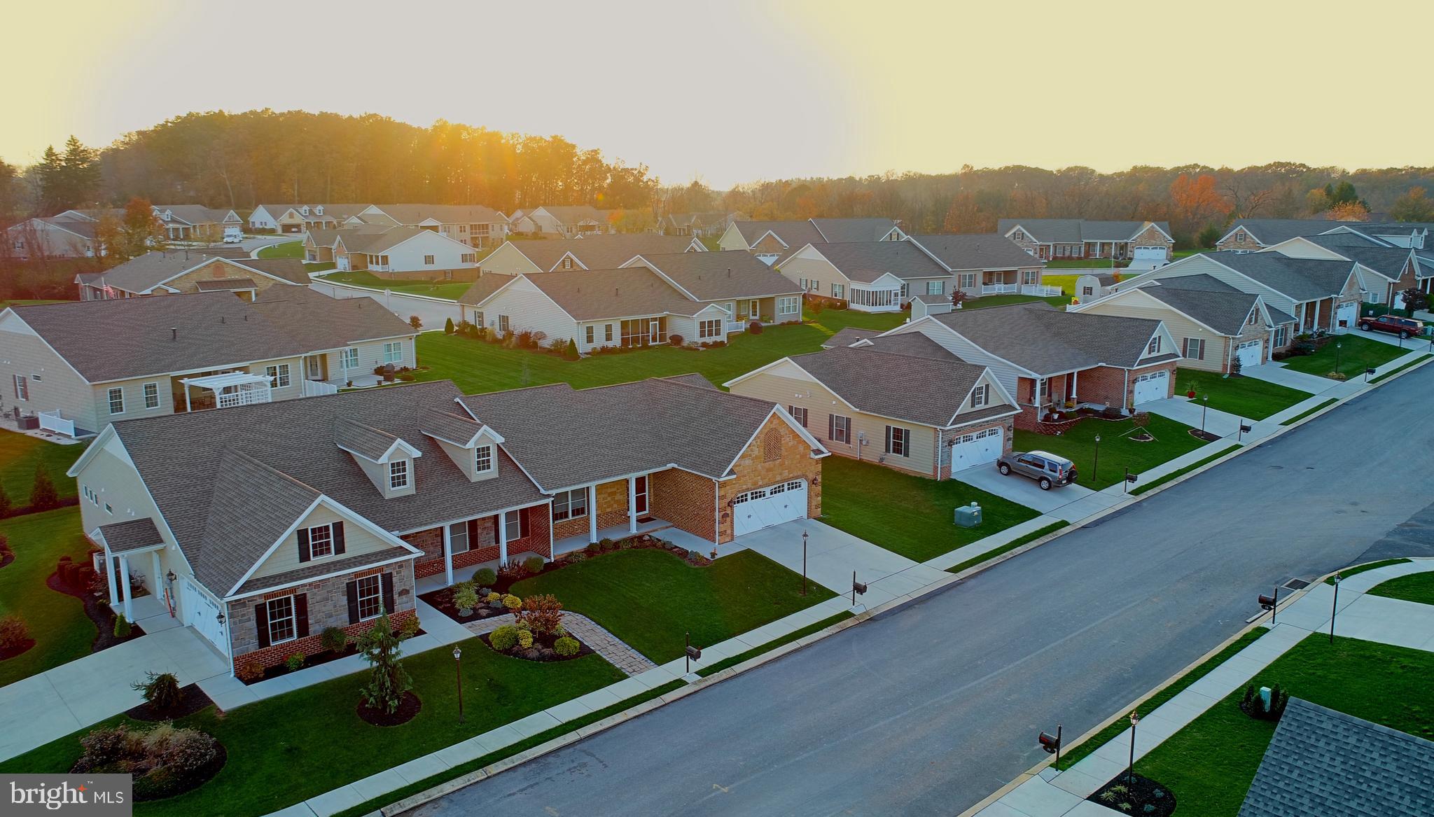 an aerial view of multiple houses with a big yard