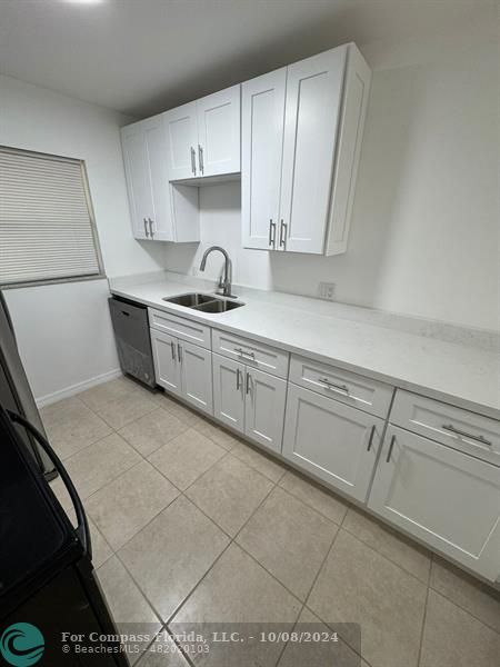 a kitchen with cabinets and white appliances