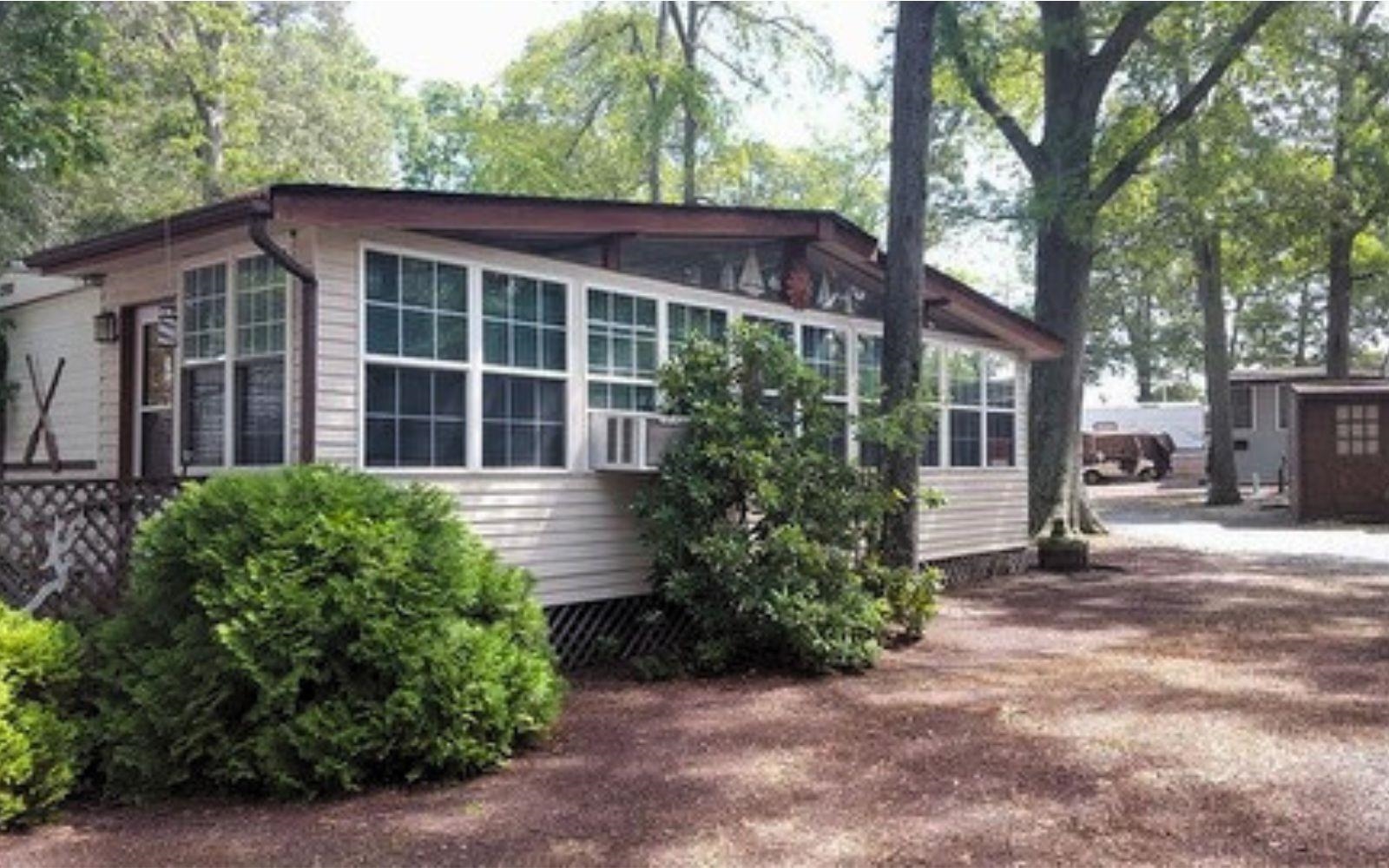 a view of a house with a yard and potted plants