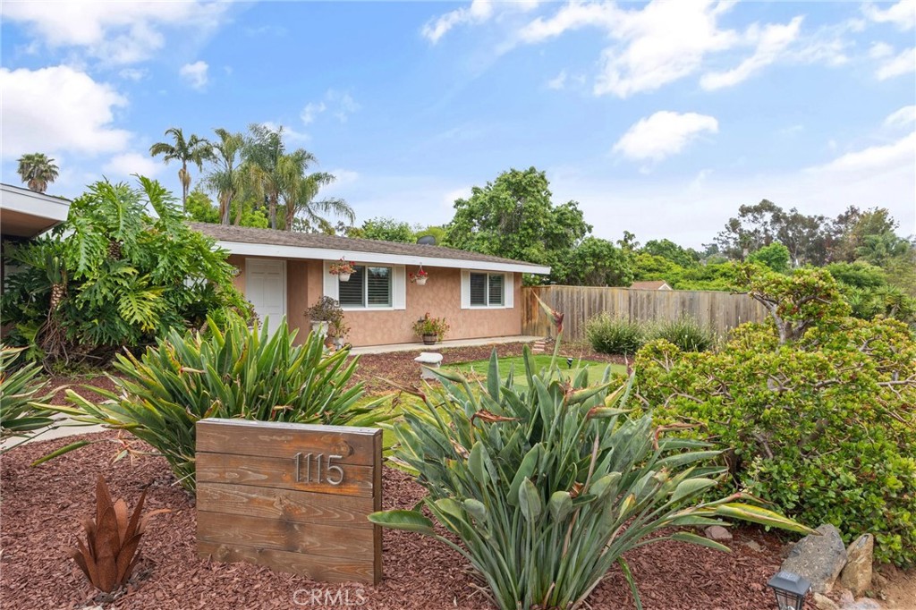 a view of a house with a small yard and plants