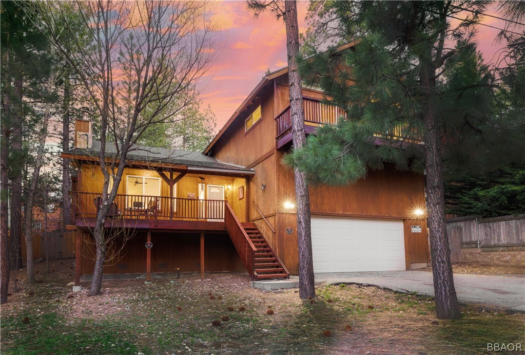 a view of backyard with large trees and a small yard