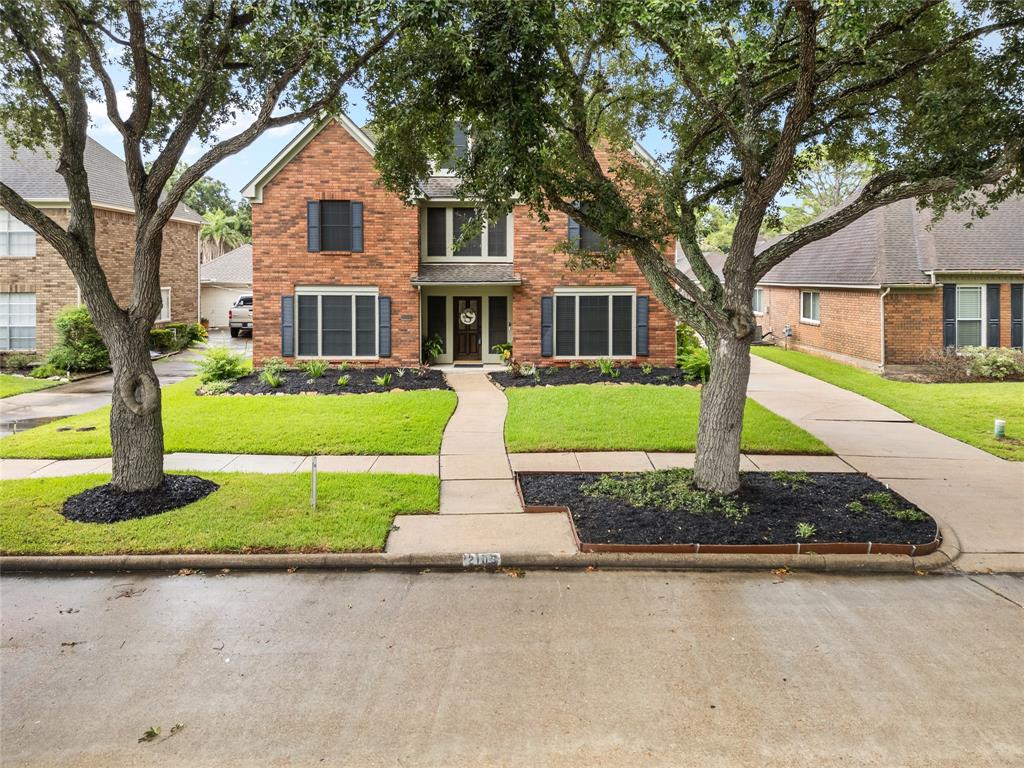 Front Elevation, with great curb appeal and solar screens