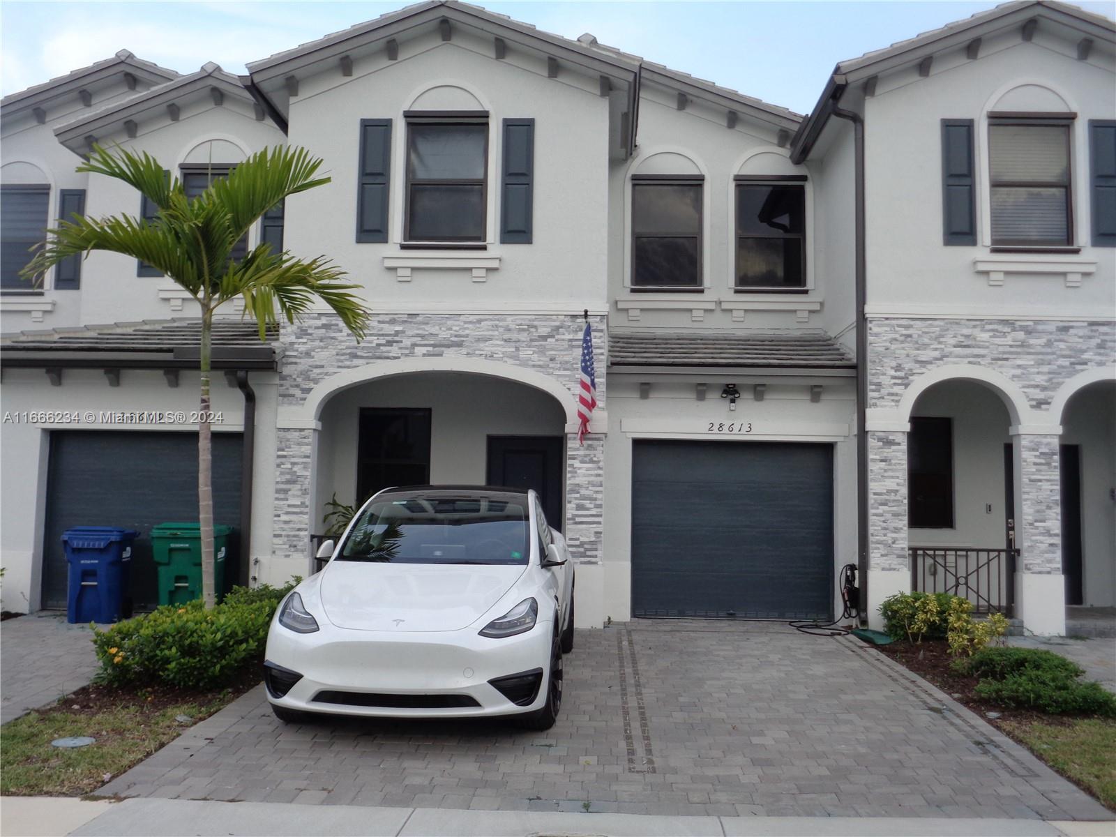 a front view of a house with garage