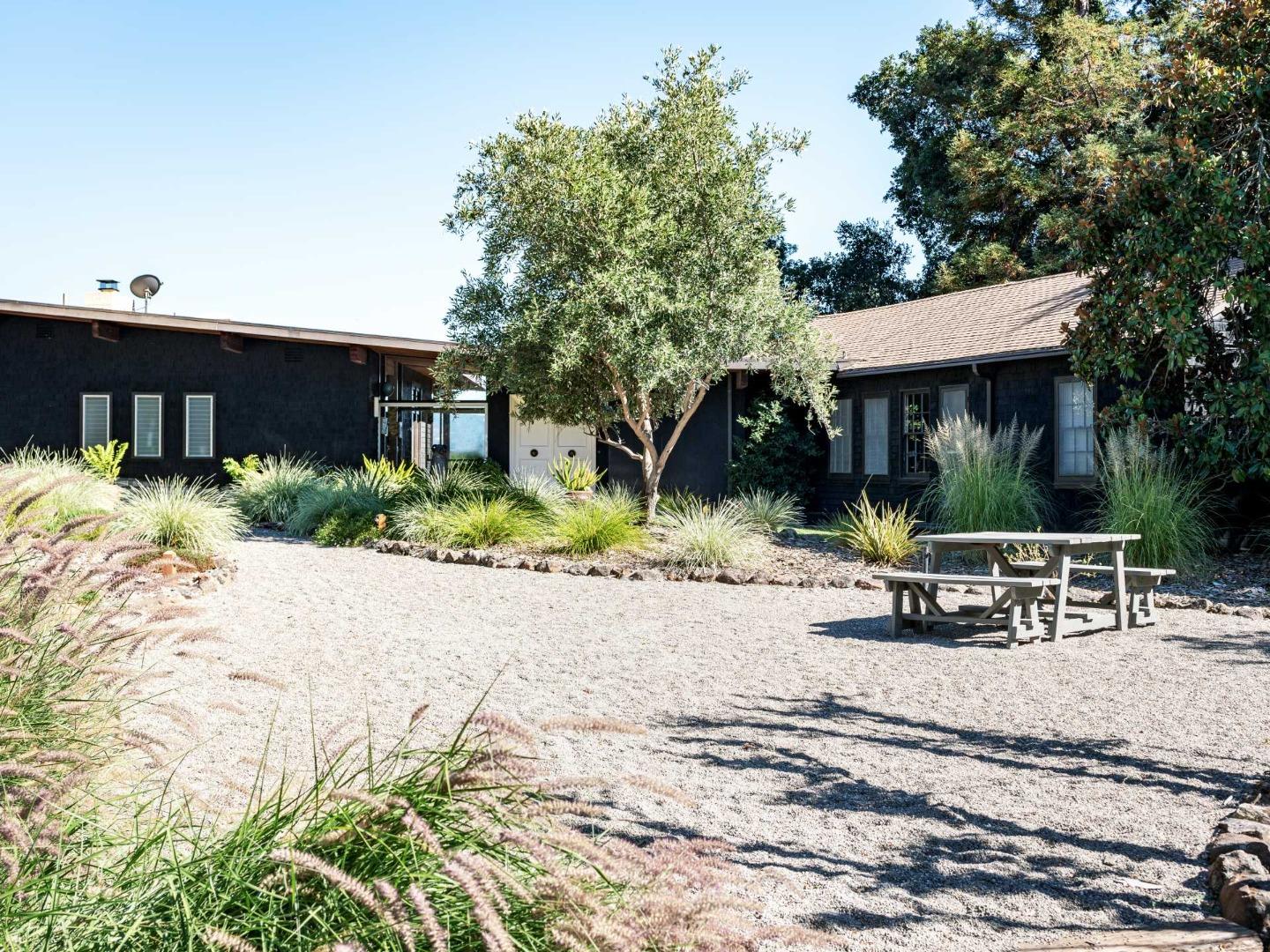 a view of a house with backyard and sitting area