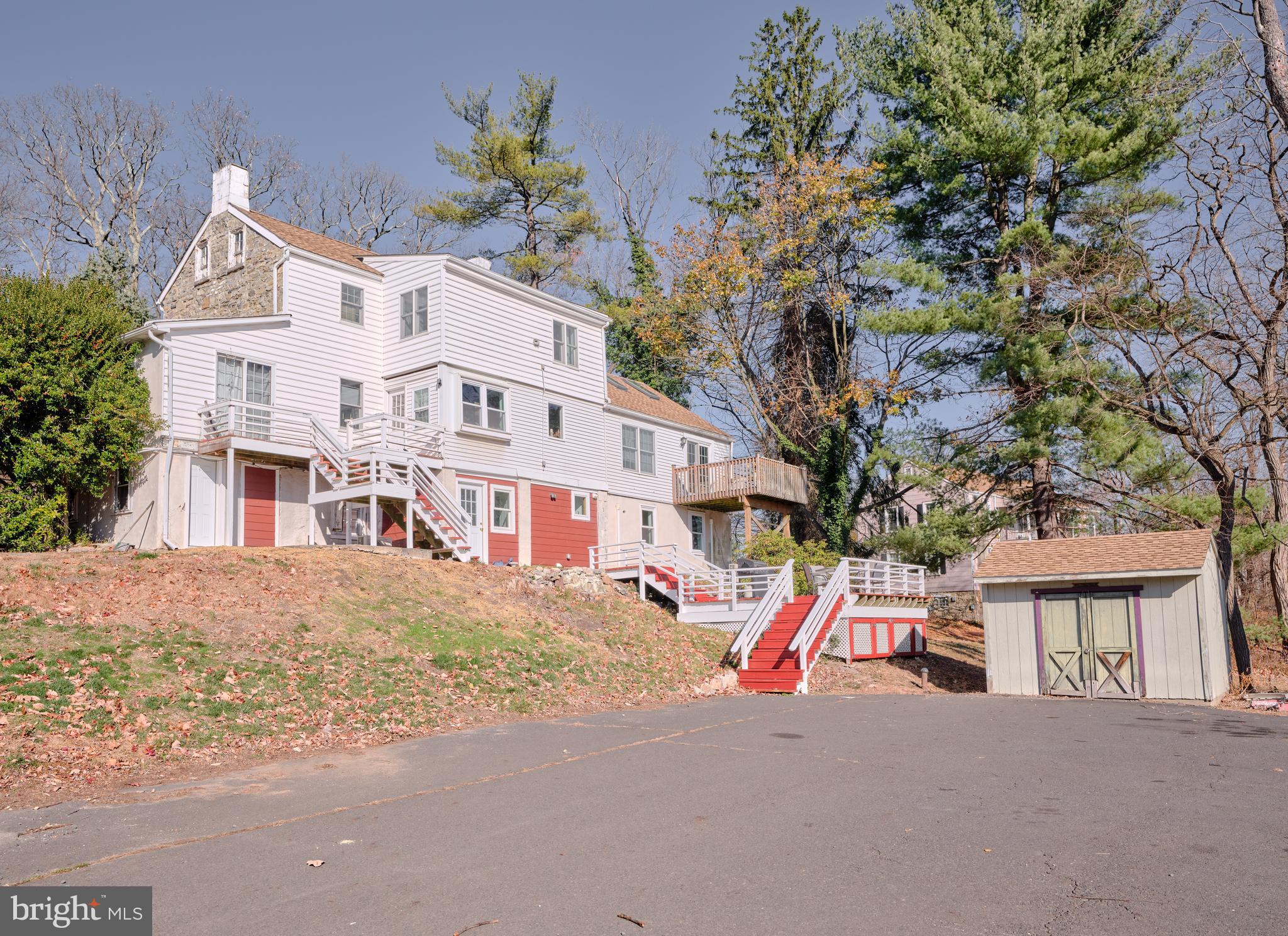 a view of a house with large windows and a tree