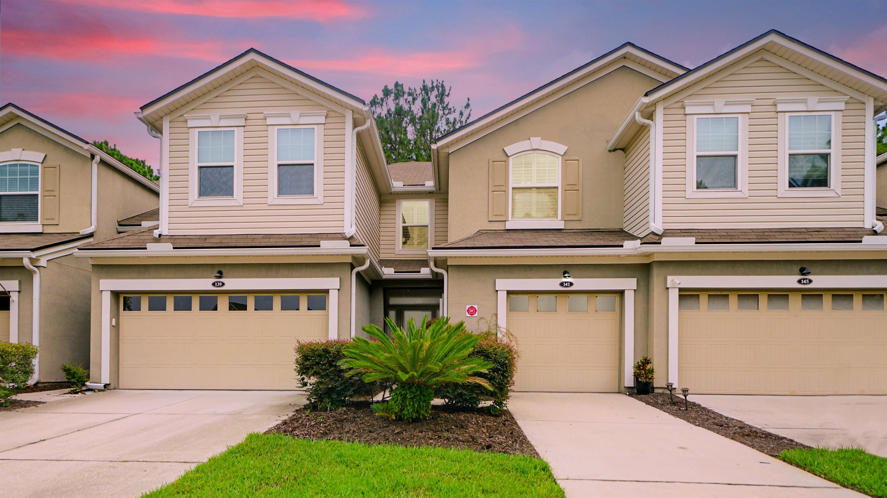 a front view of a house with a yard and garage