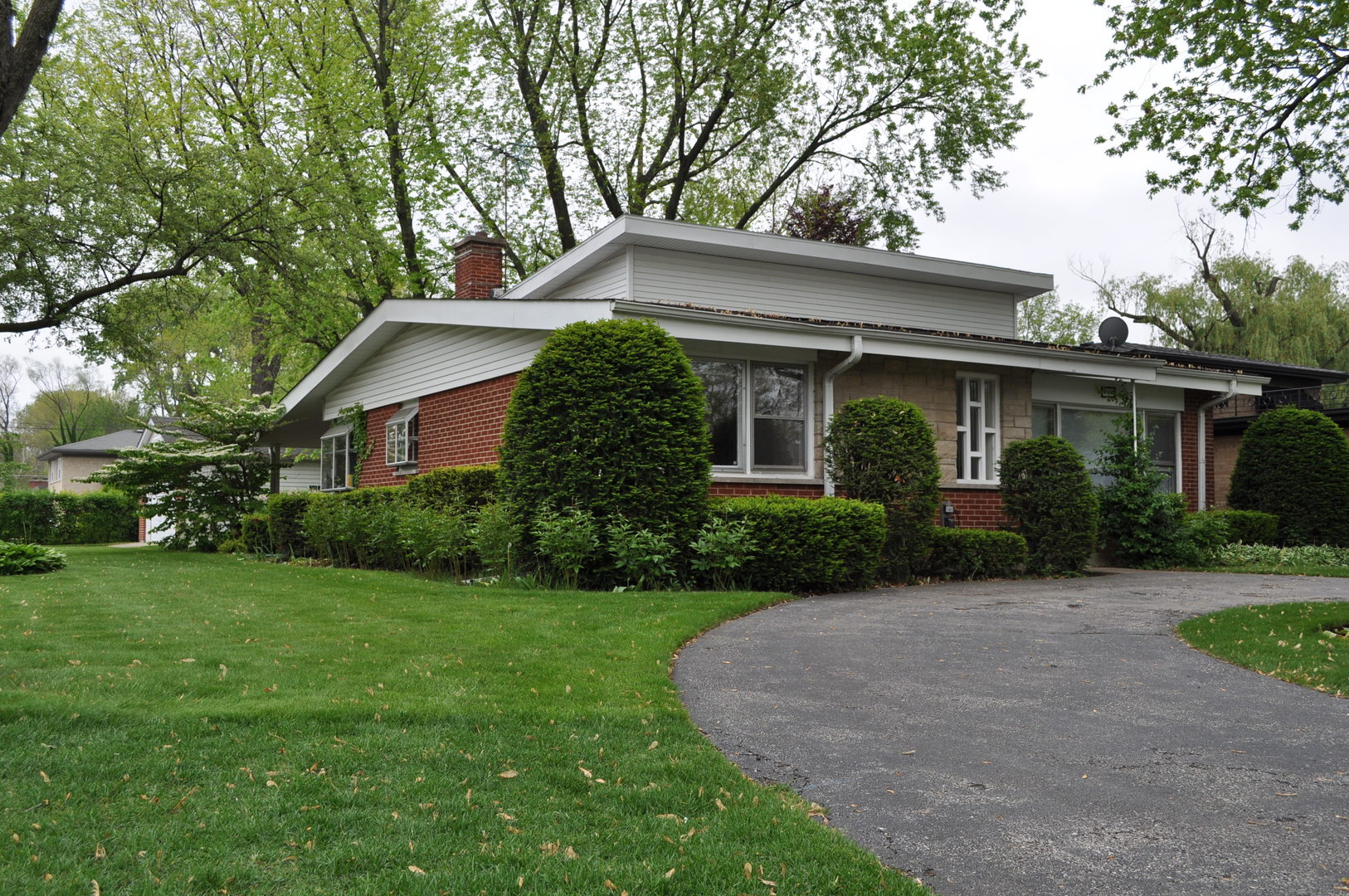 a front view of house with yard and green space