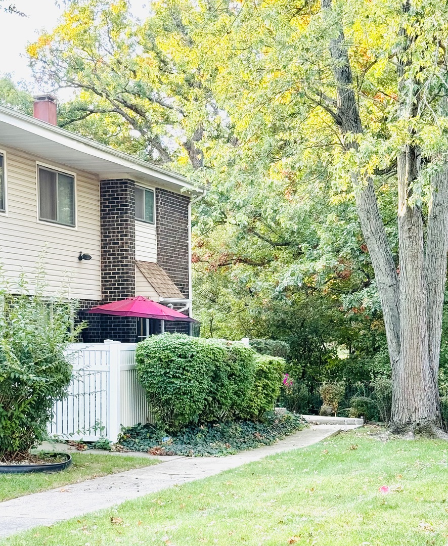 a view of a house with a yard and garage