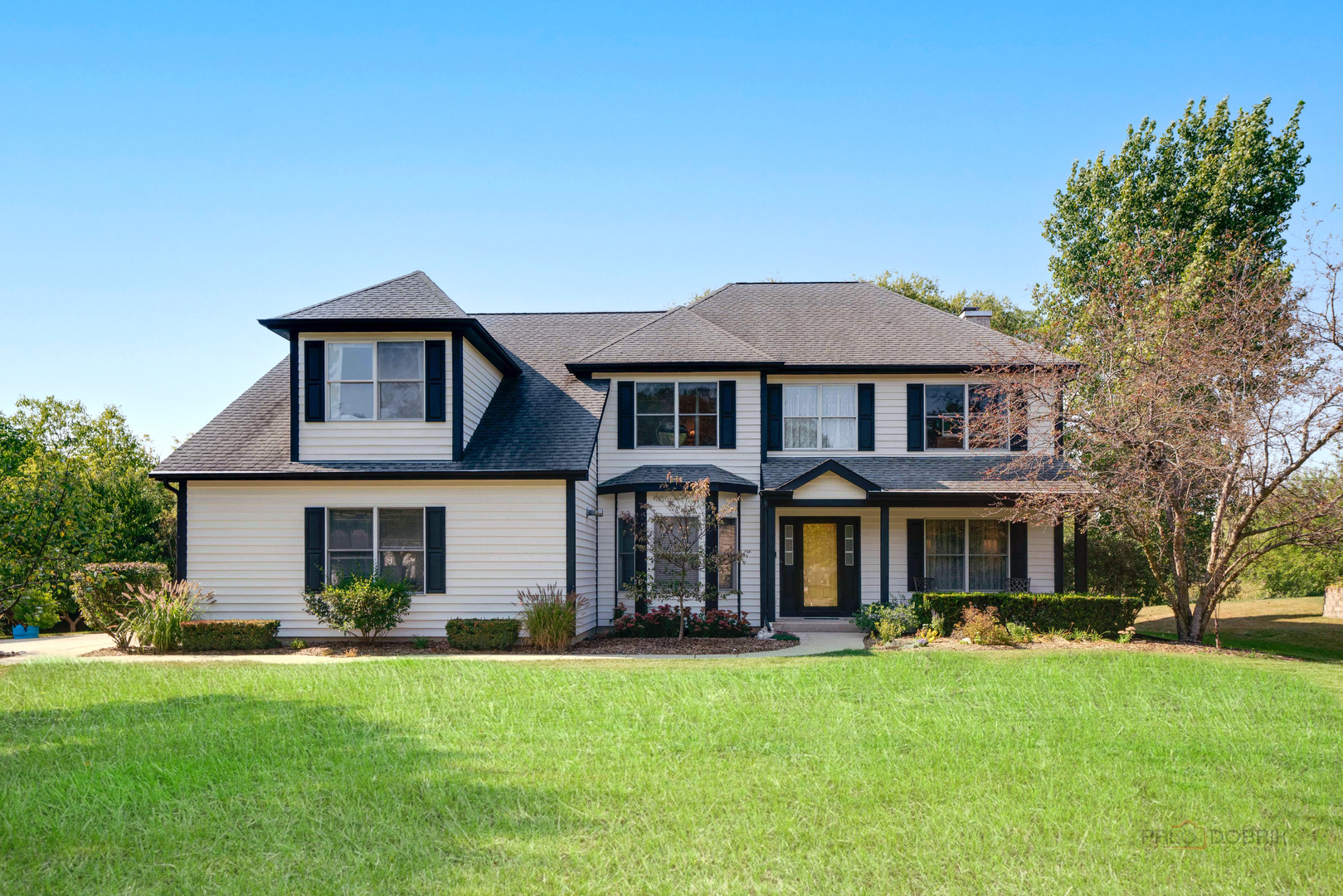 a front view of a house with a yard