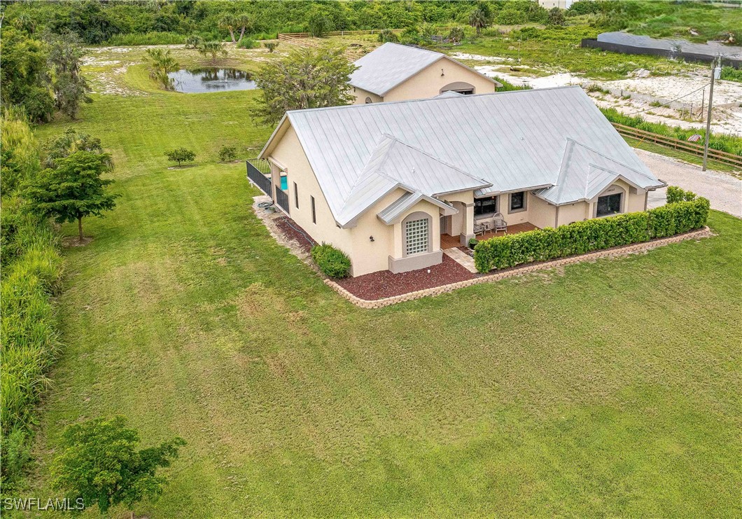 an aerial view of residential houses with outdoor space and swimming pool