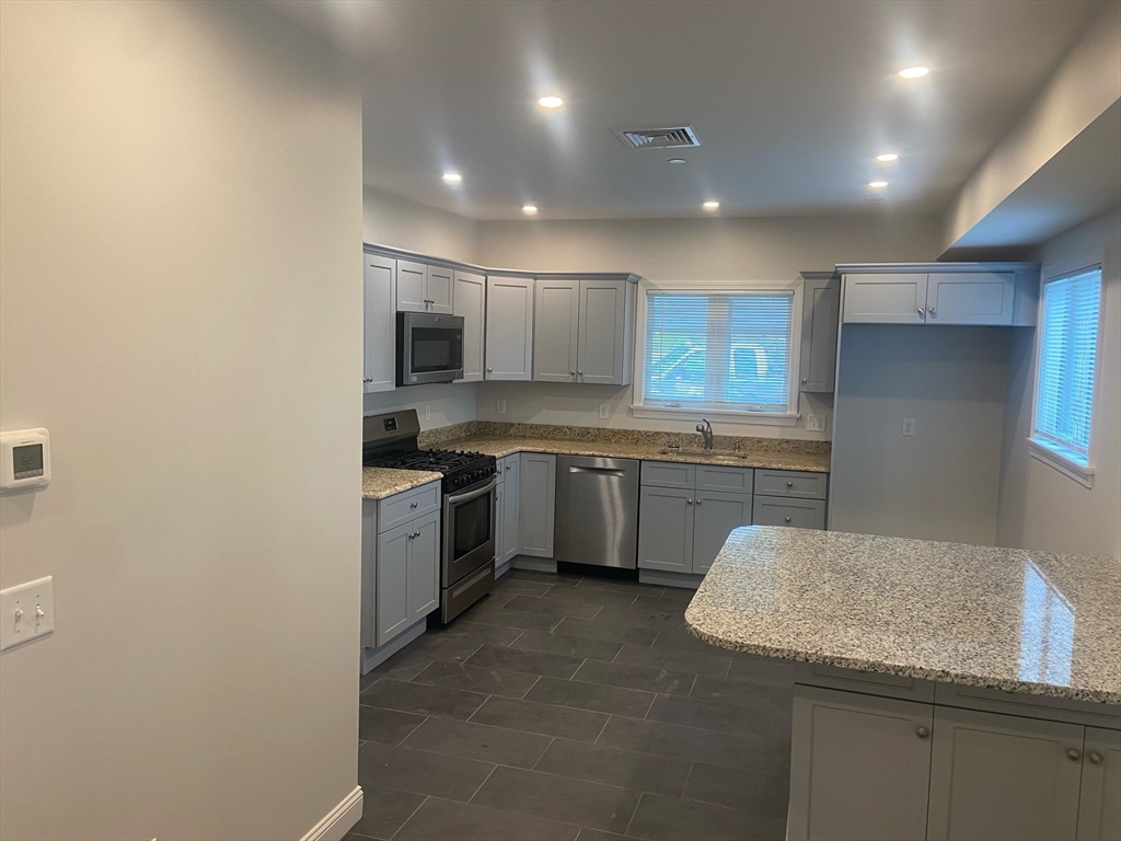 a kitchen with a sink cabinets and stainless steel appliances